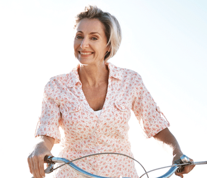 Smiling Middle aged woman riding a bicycle